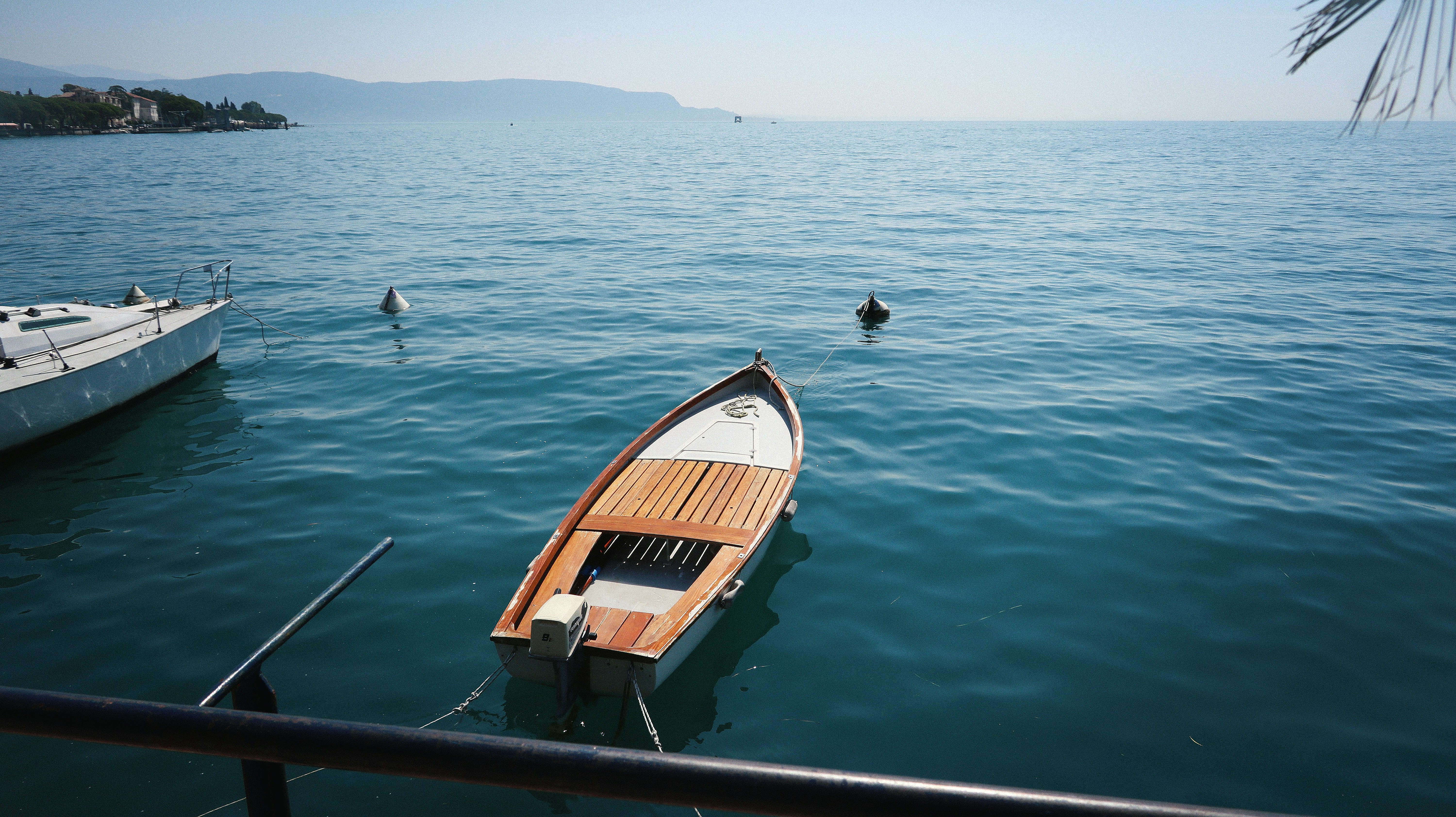 a small boat floating on top of a body of water, Italian summer_23