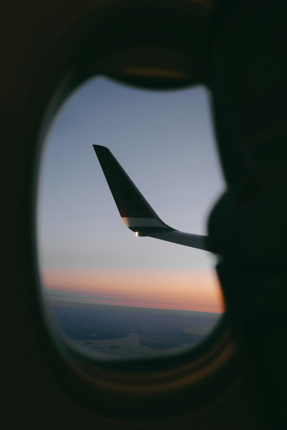 a view of the wing of an airplane through a window