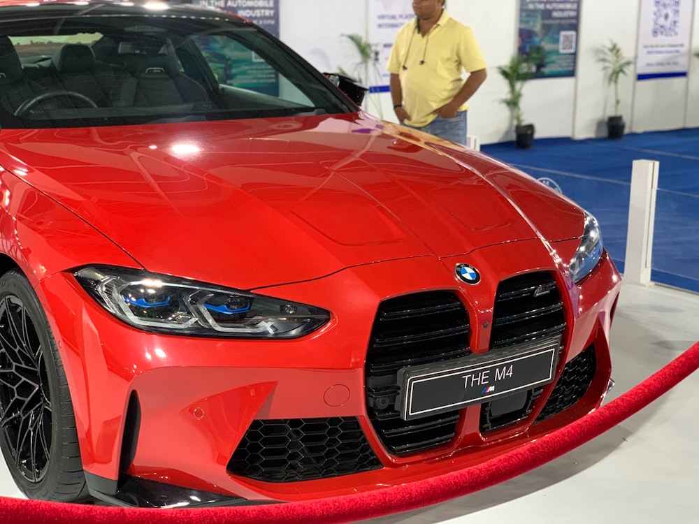 a red sports car on display at a car show