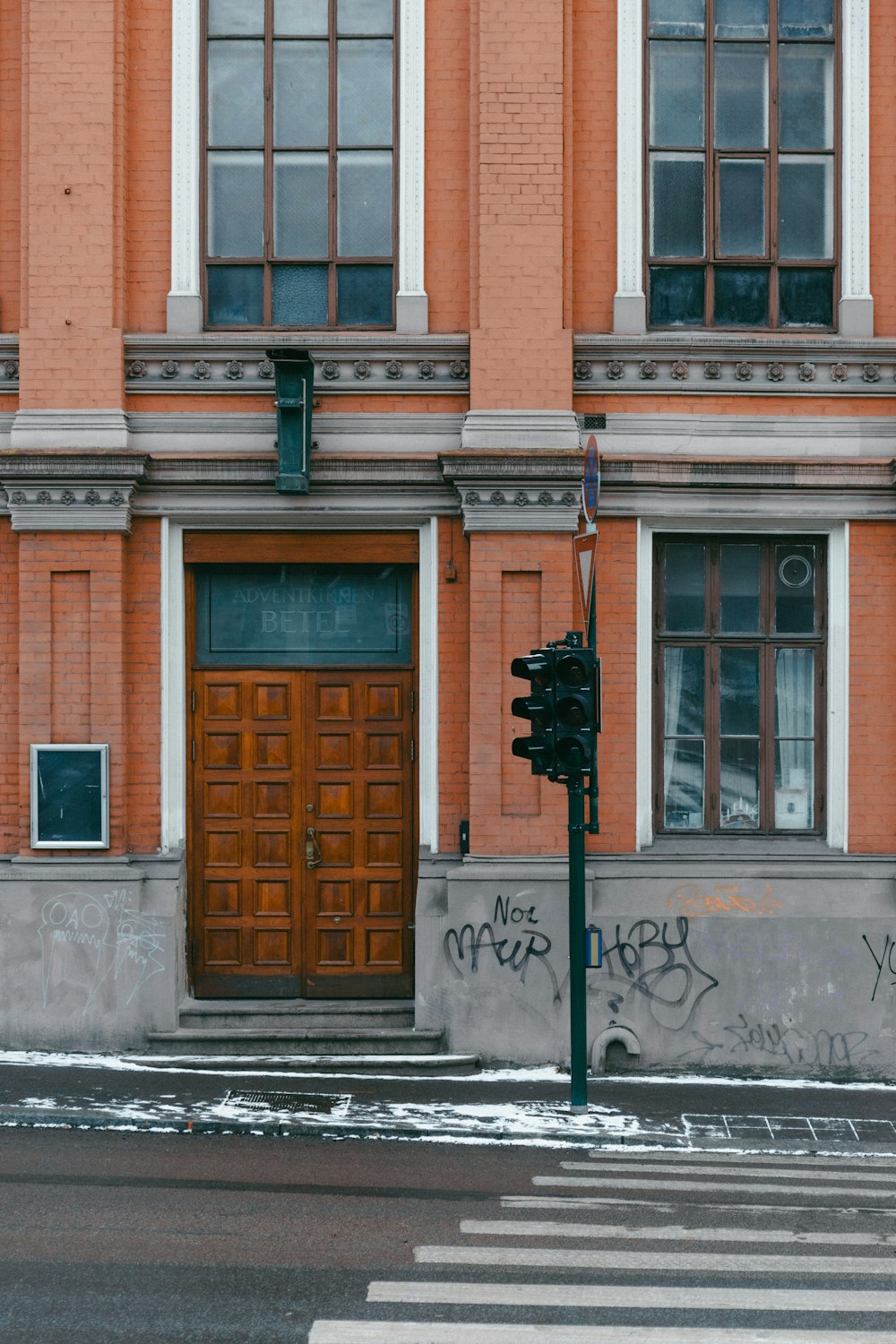 a red brick building with graffiti on the side of it