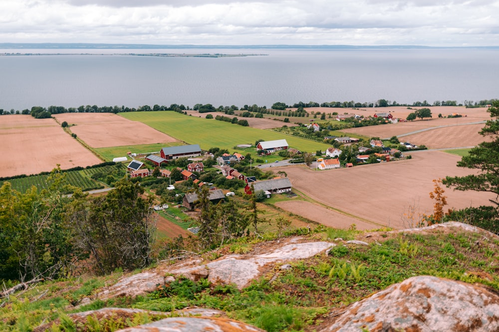 a scenic view of a small town and a body of water