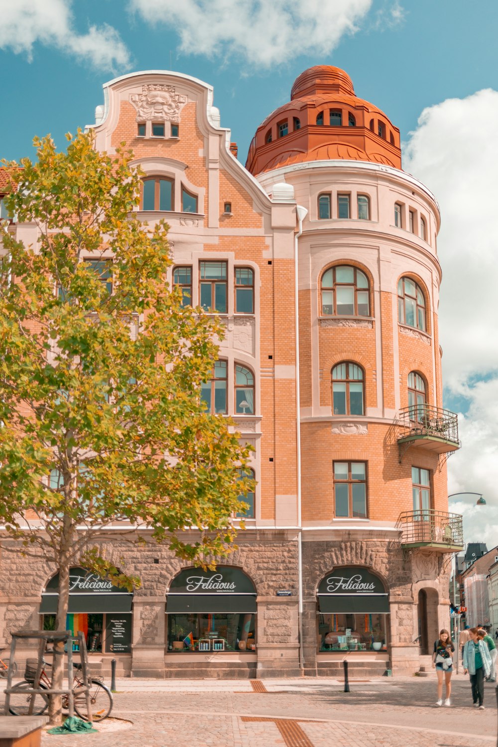 a large building with a tree in front of it