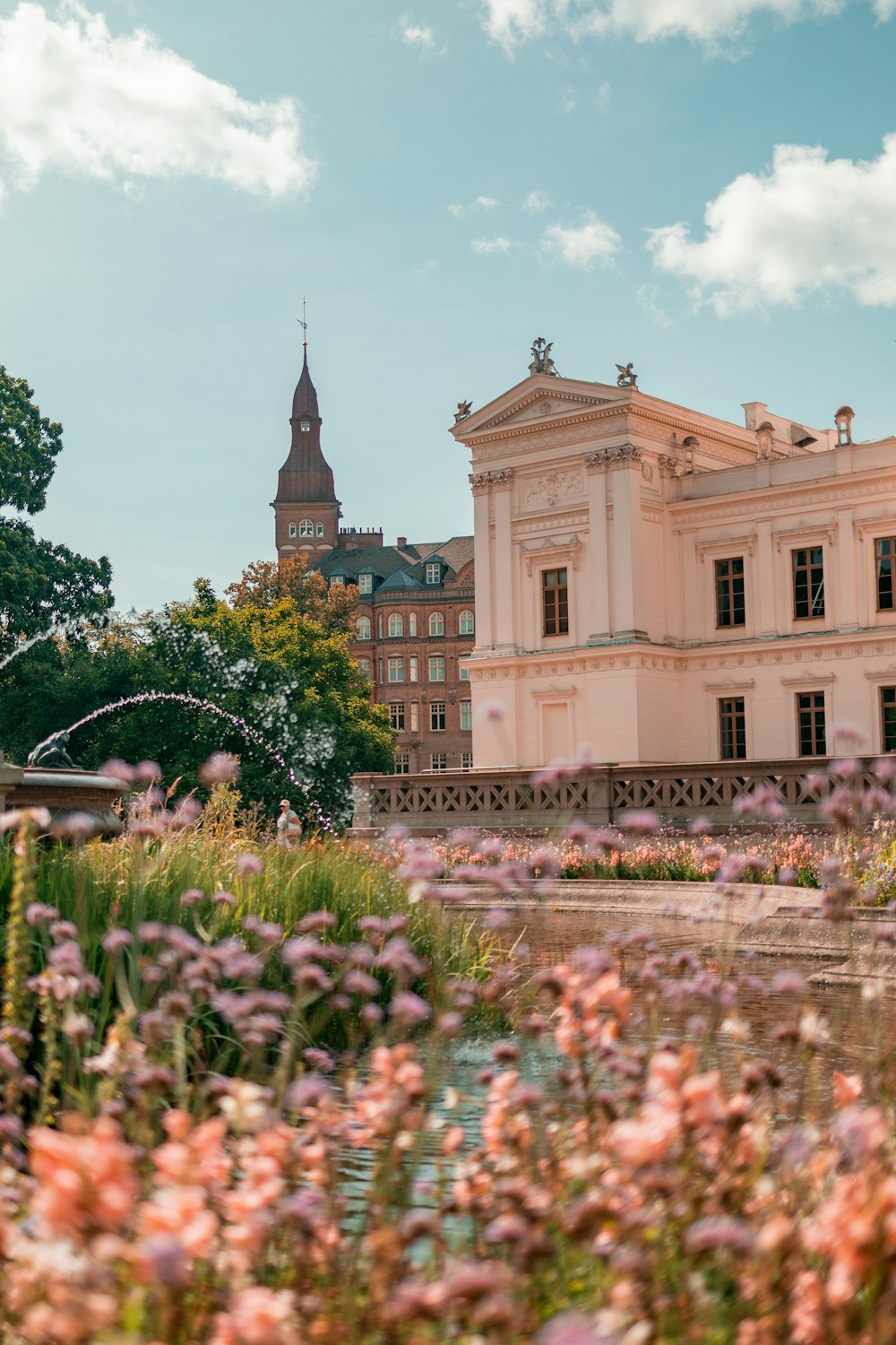 a large building with a fountain in front of it