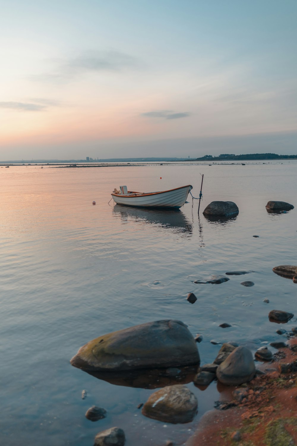 a small boat sitting on top of a body of water