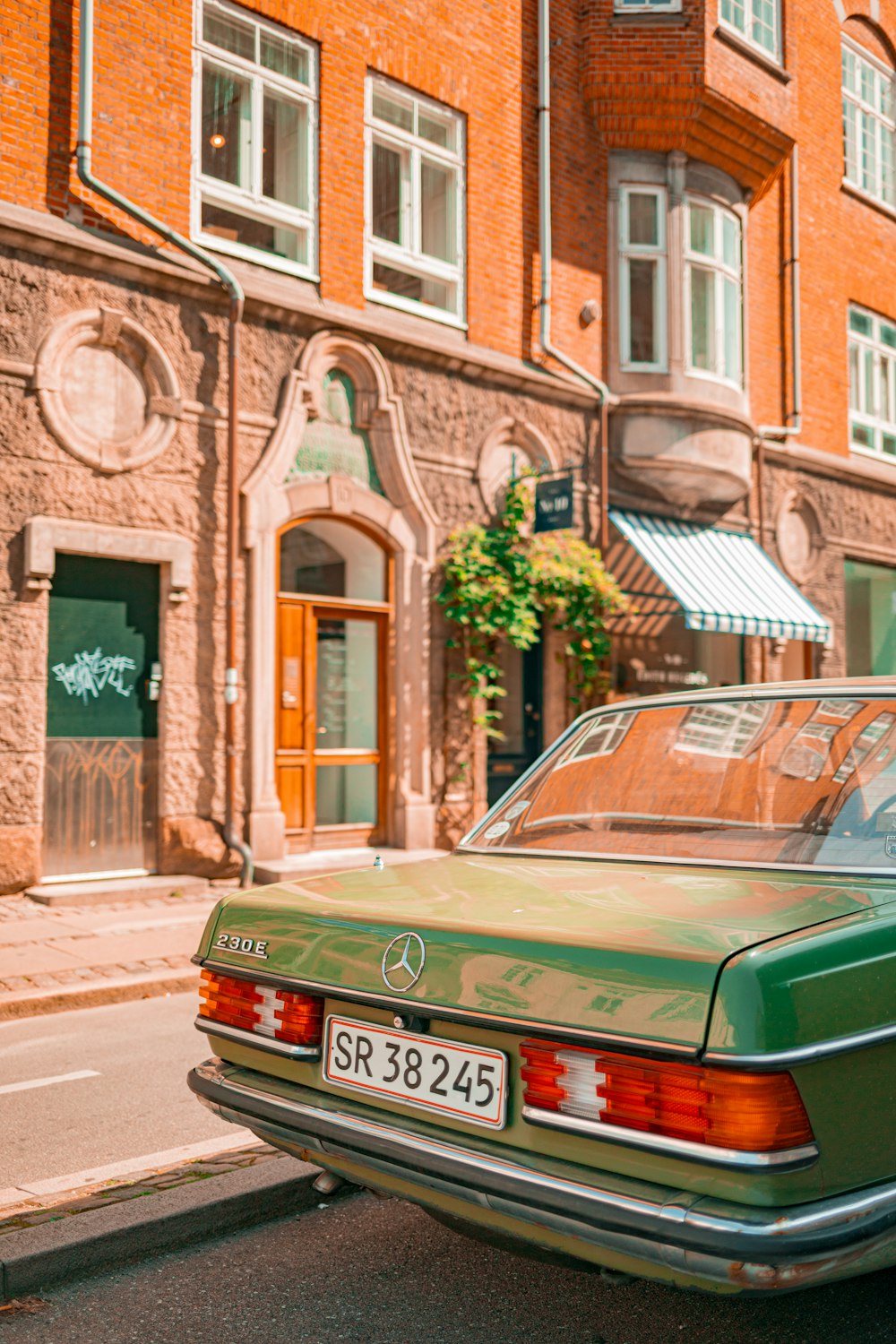 a green car parked on the side of the road