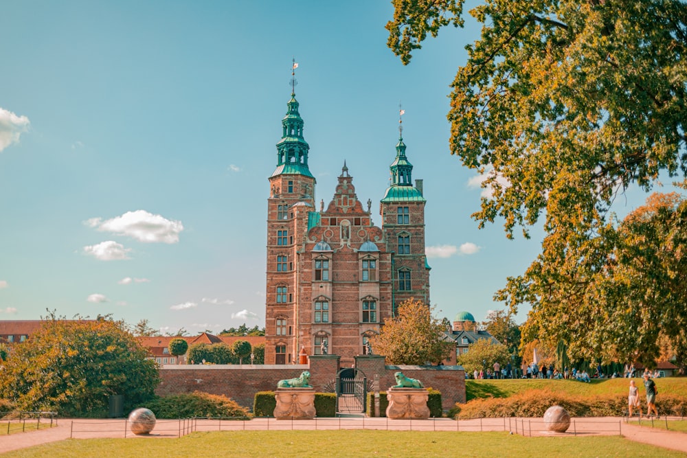 a large brick building with two towers on top of it