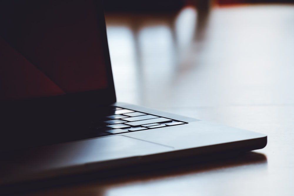 a laptop computer sitting on top of a wooden table