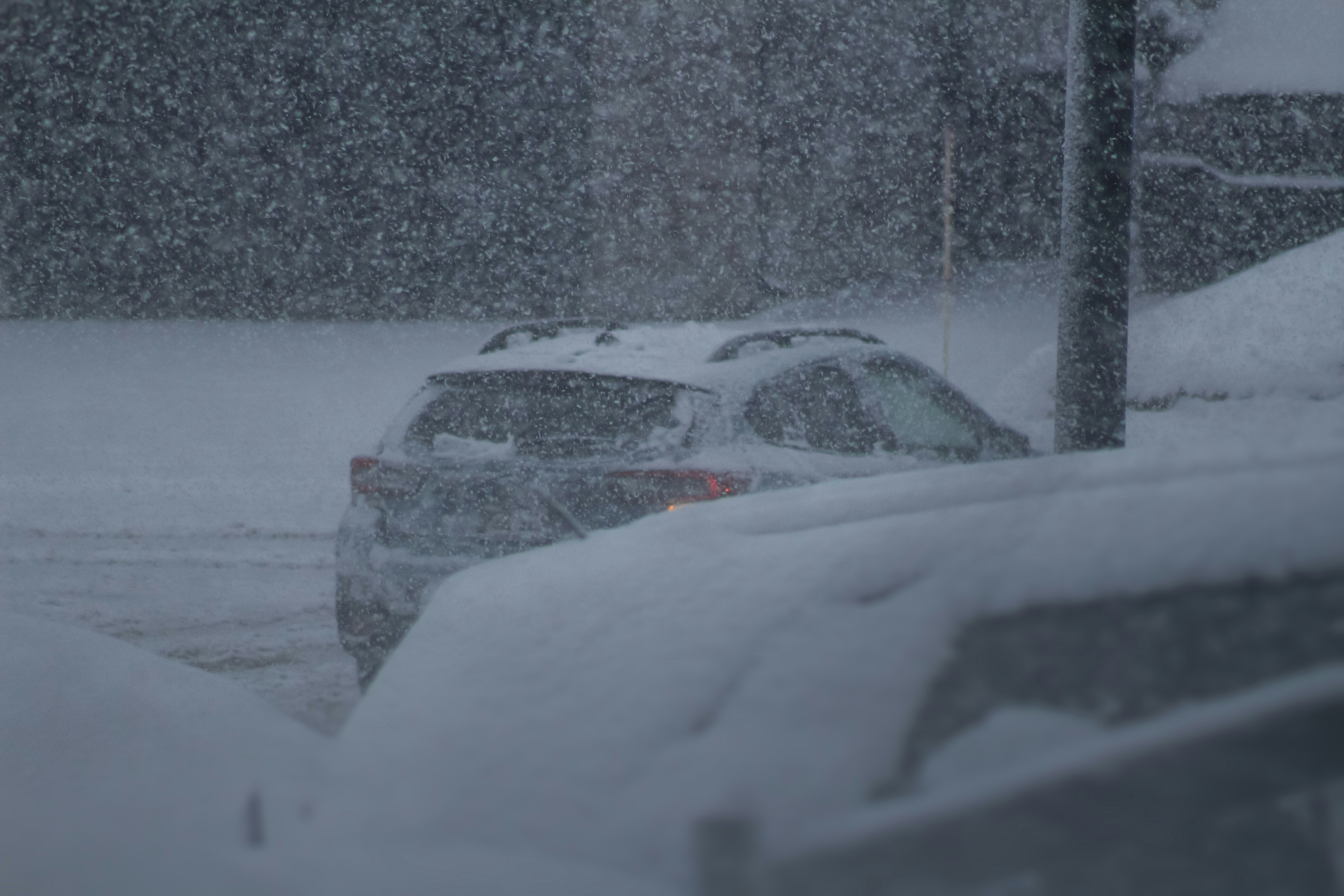 a couple of cars parked on a snowy street