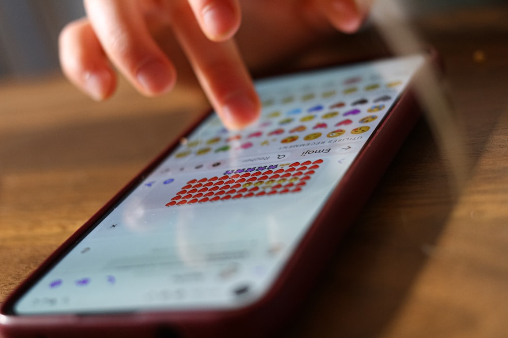 a close up of a person touching a cell phone