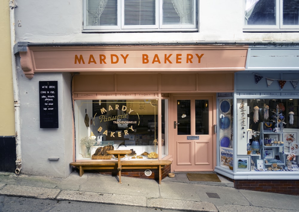 a store front with a wooden bench in front of it