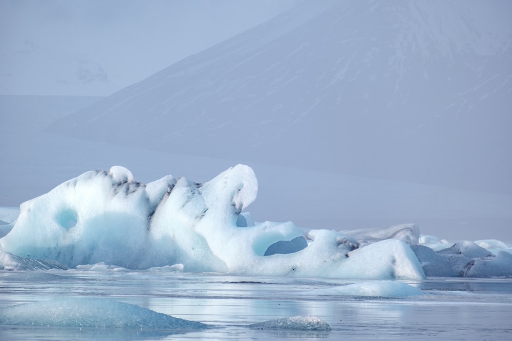 a large iceberg floating on top of a body of water