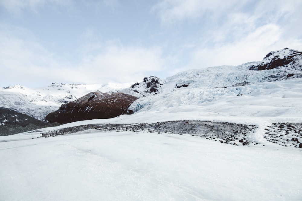 a man riding skis down a snow covered slope