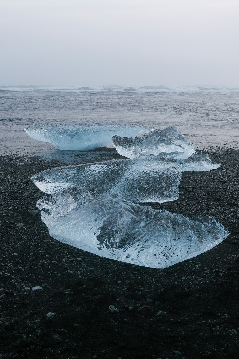 a group of icebergs floating on top of a body of water