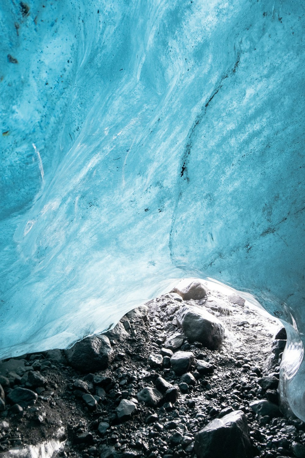 a large ice cave with rocks and water