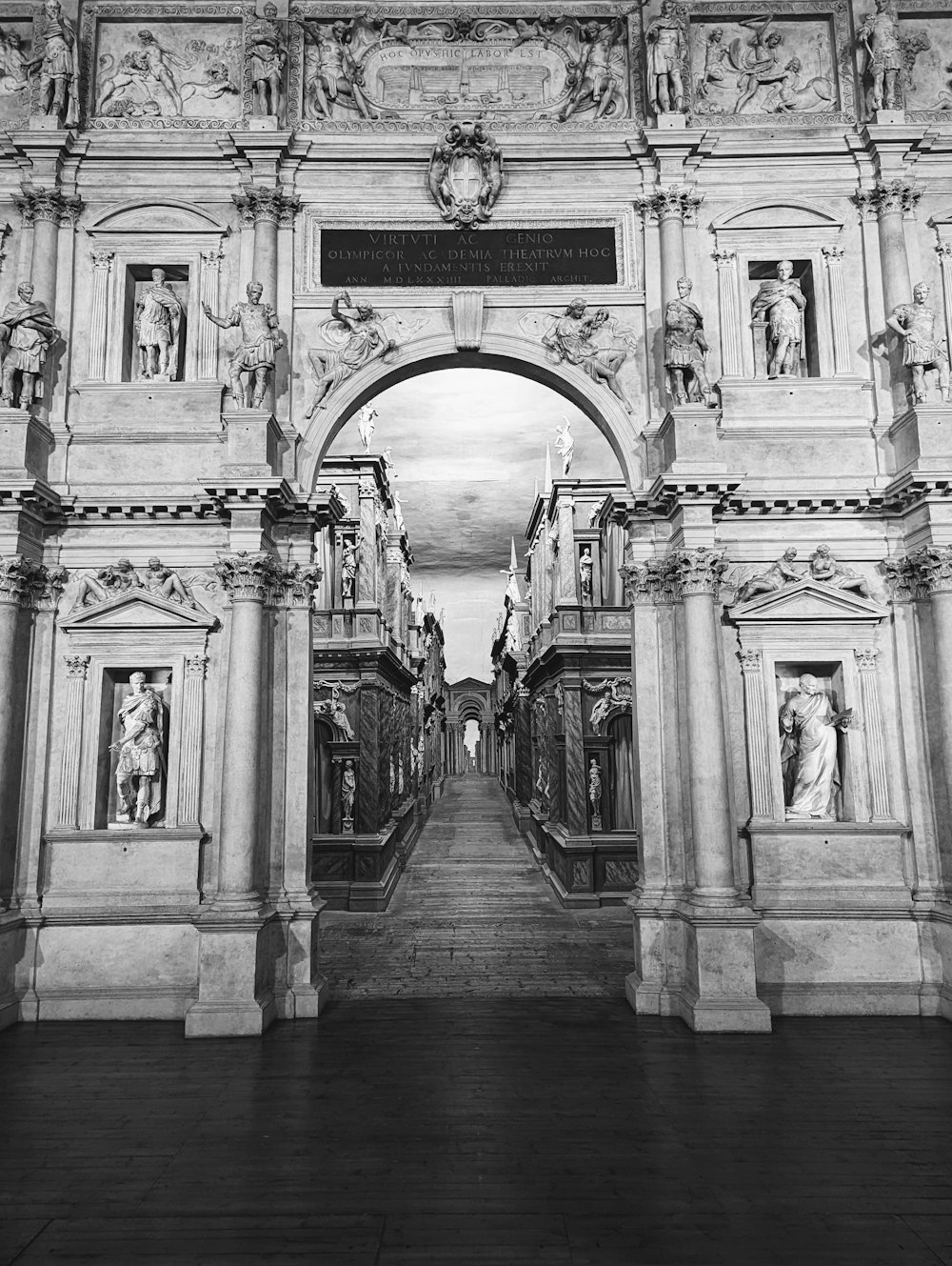 a black and white photo of a large arch