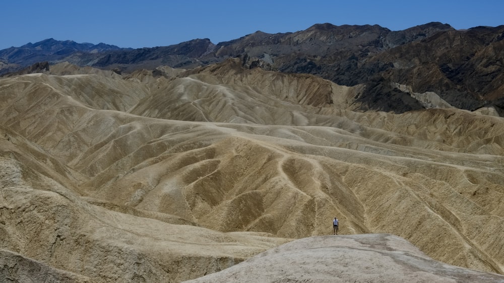 a person standing on top of a large mountain