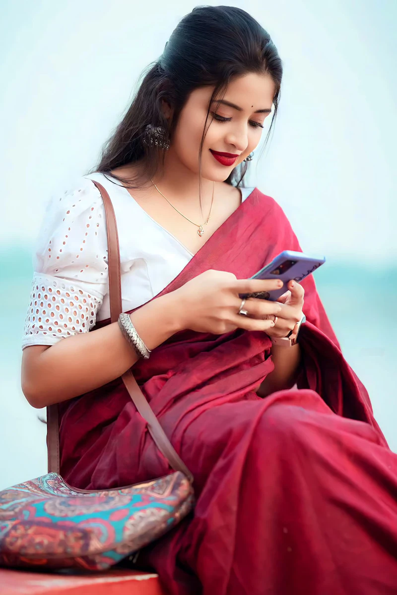 Woman smiling at her phone on a bench