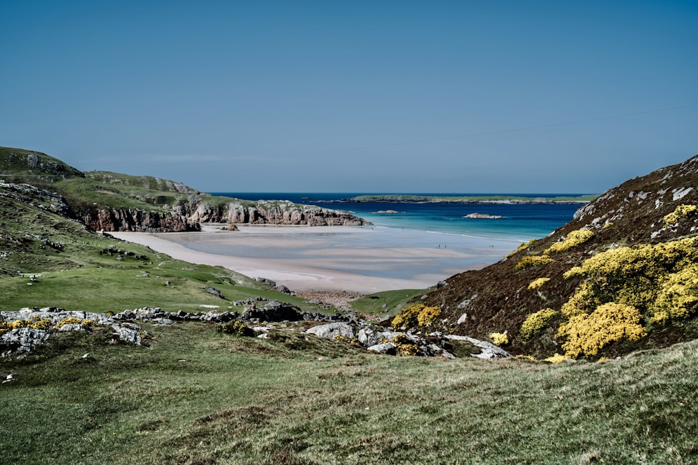 a view of a beach from the top of a hill