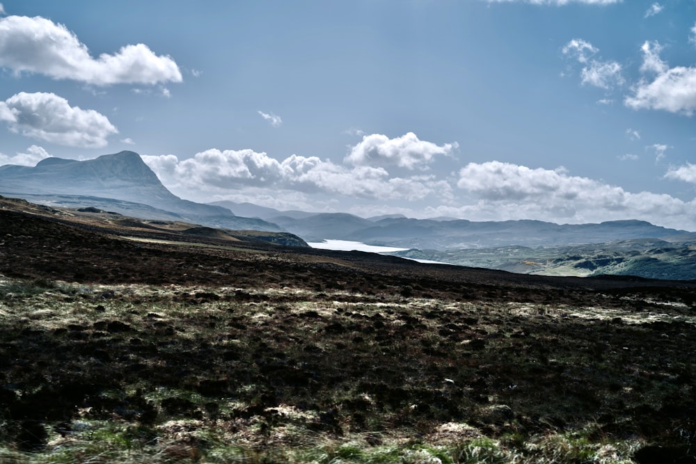 a mountain range with a body of water in the distance