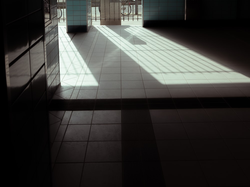 a room with a tiled floor and a large window