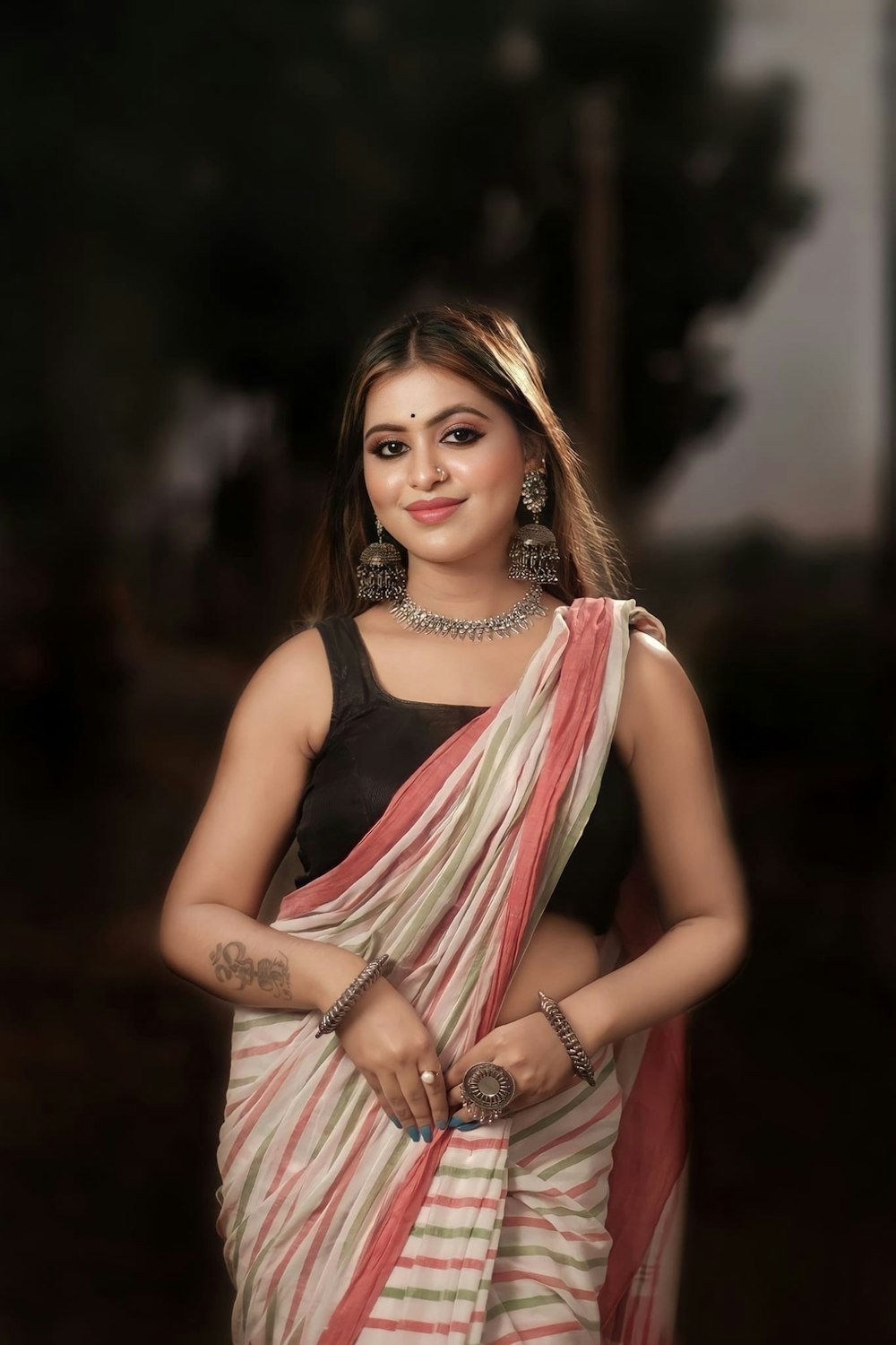 a woman in a sari posing for a picture