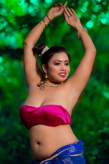 a woman in a pink top and blue skirt