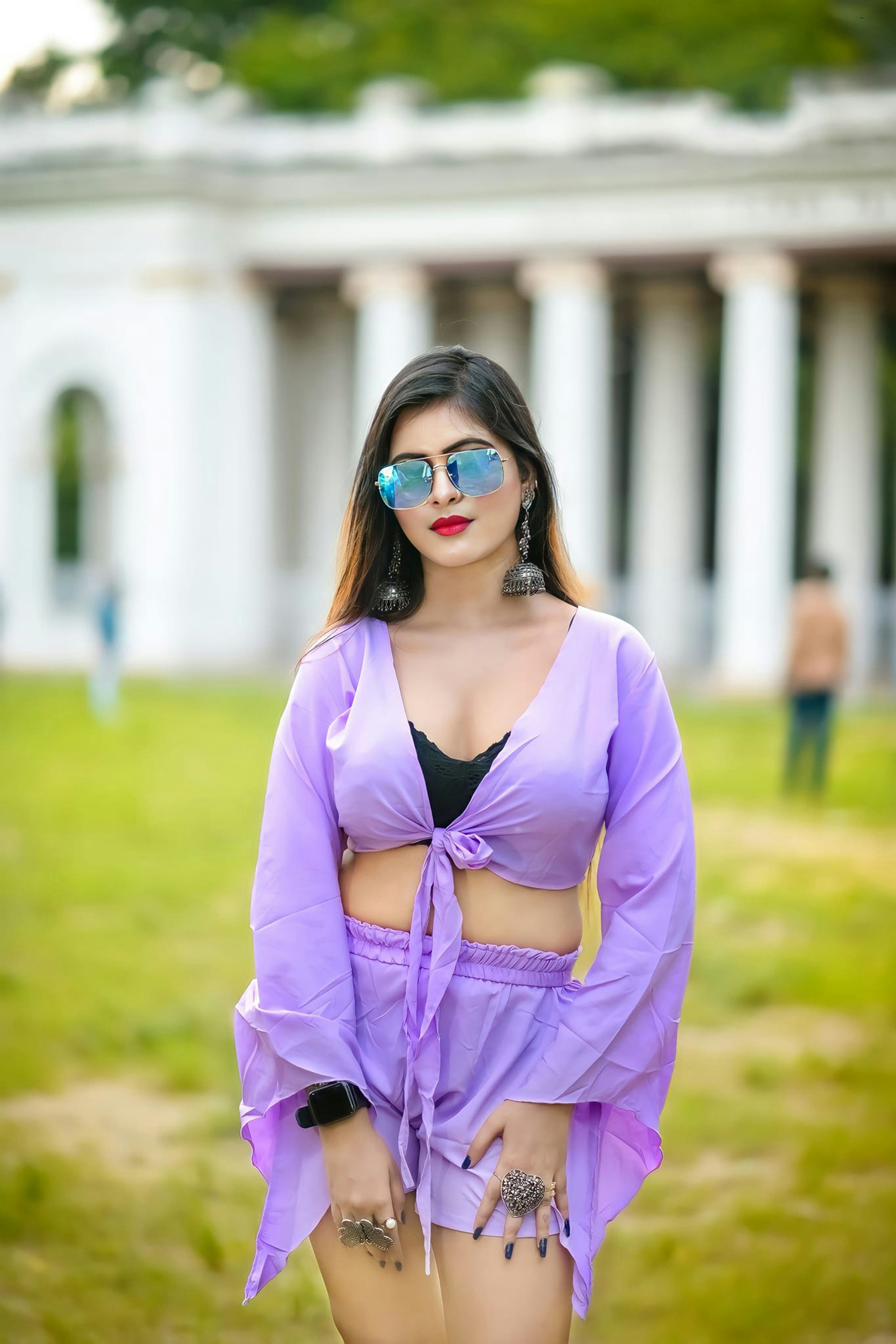 a woman in a purple outfit standing in front of a building