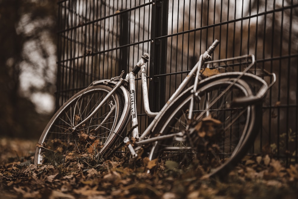a close up of a bike in front of a fence