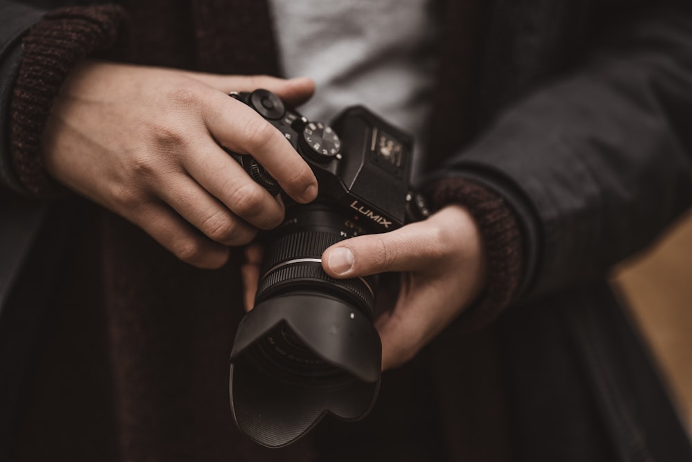 a person holding a camera in their hands