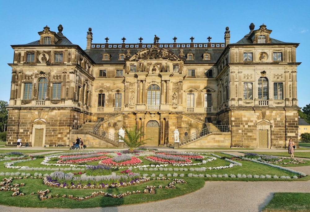 a large building with a garden in front of it