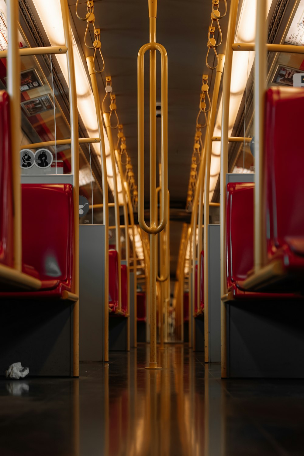 the interior of a public transit bus with red seats