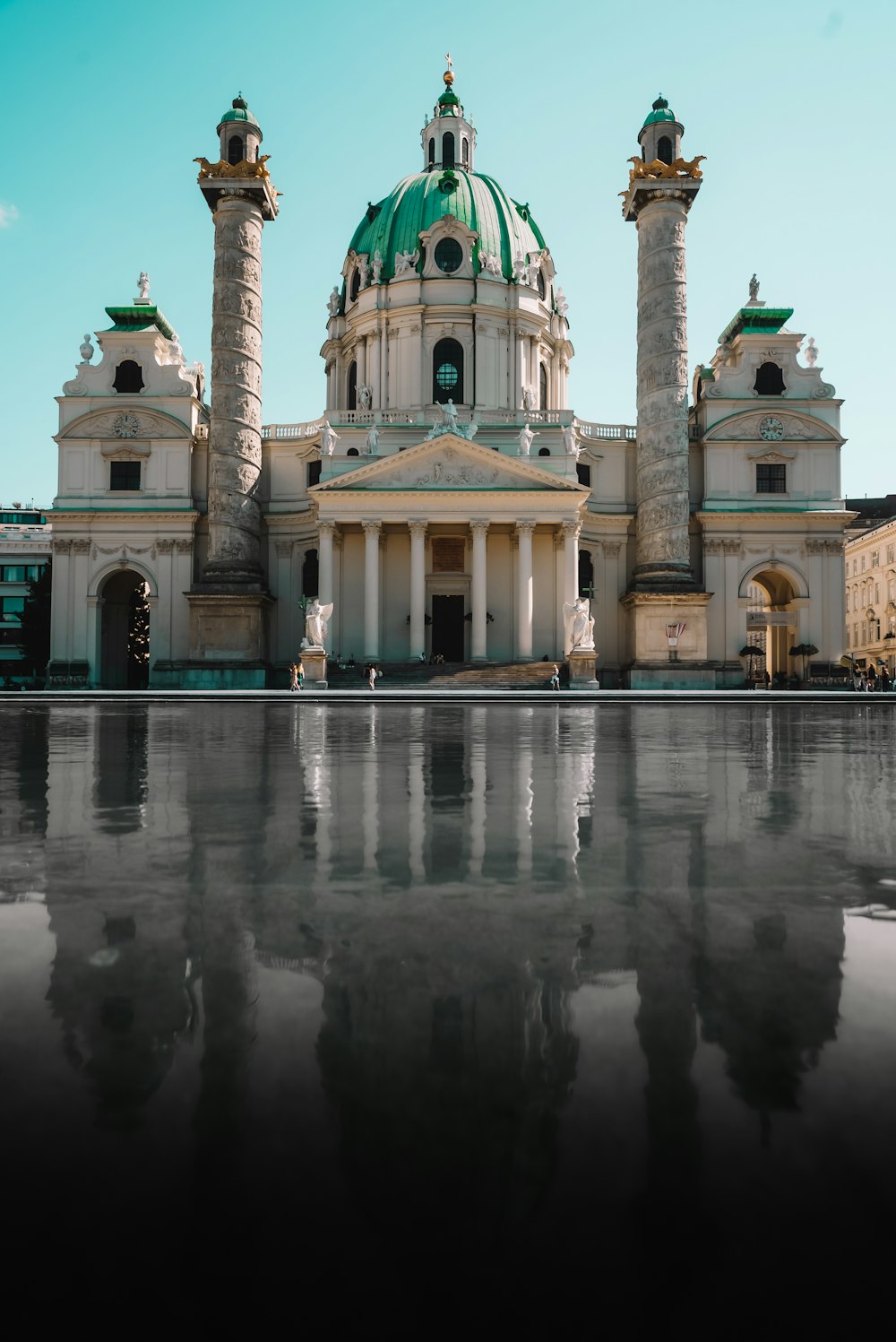 a large white building with a green dome