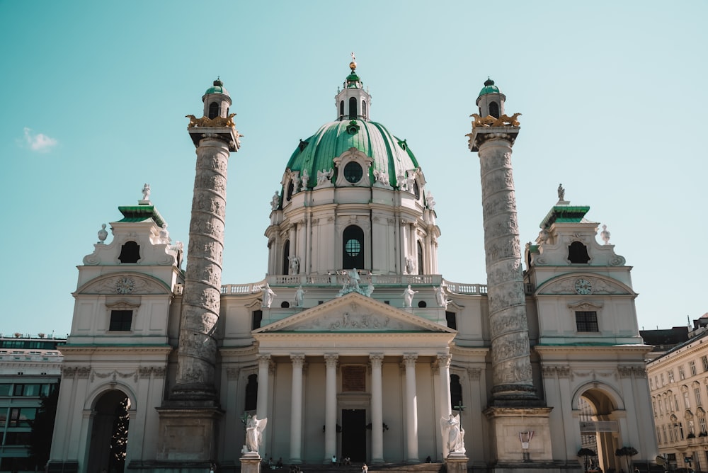 a large white building with a green dome