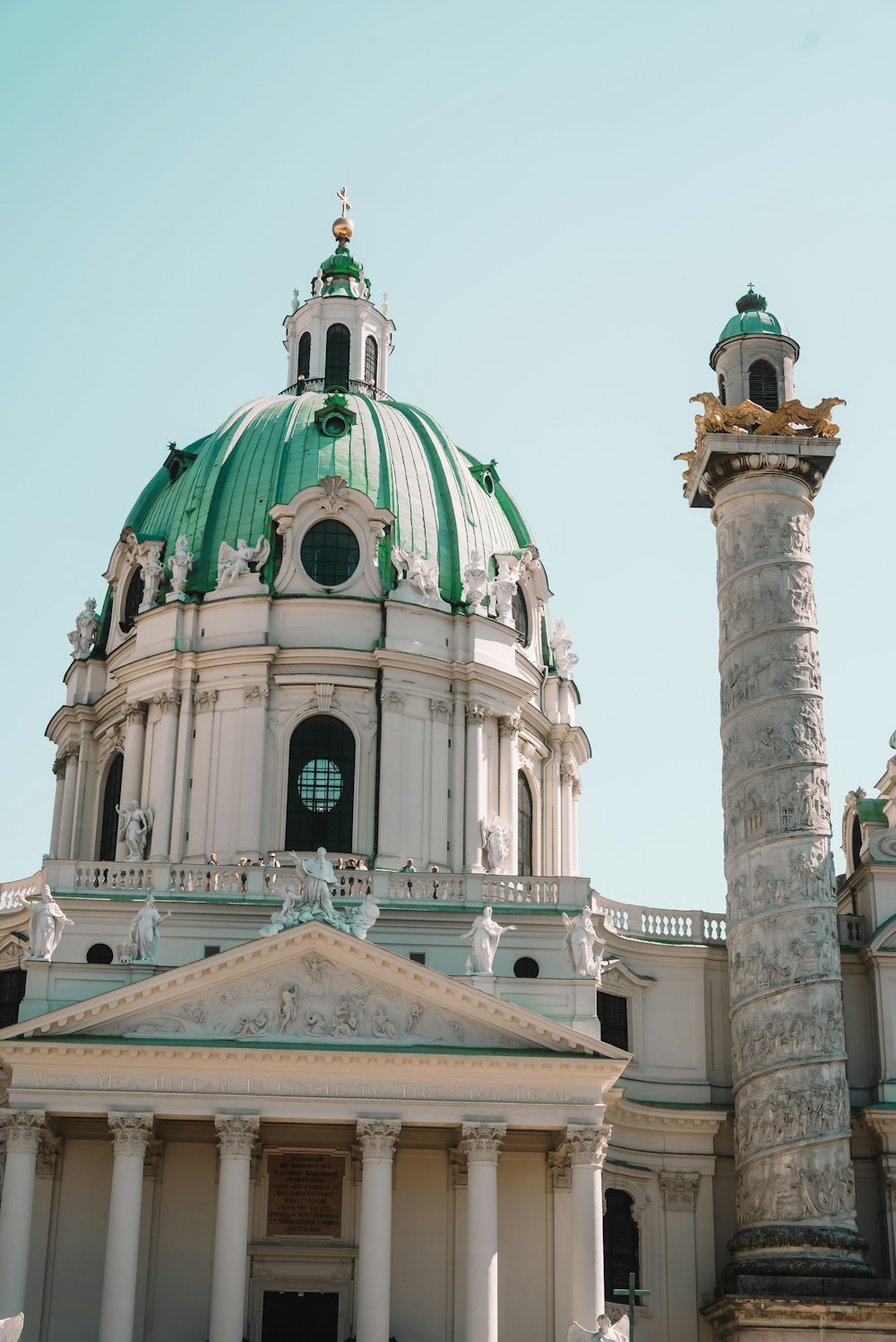 a large white building with a green dome