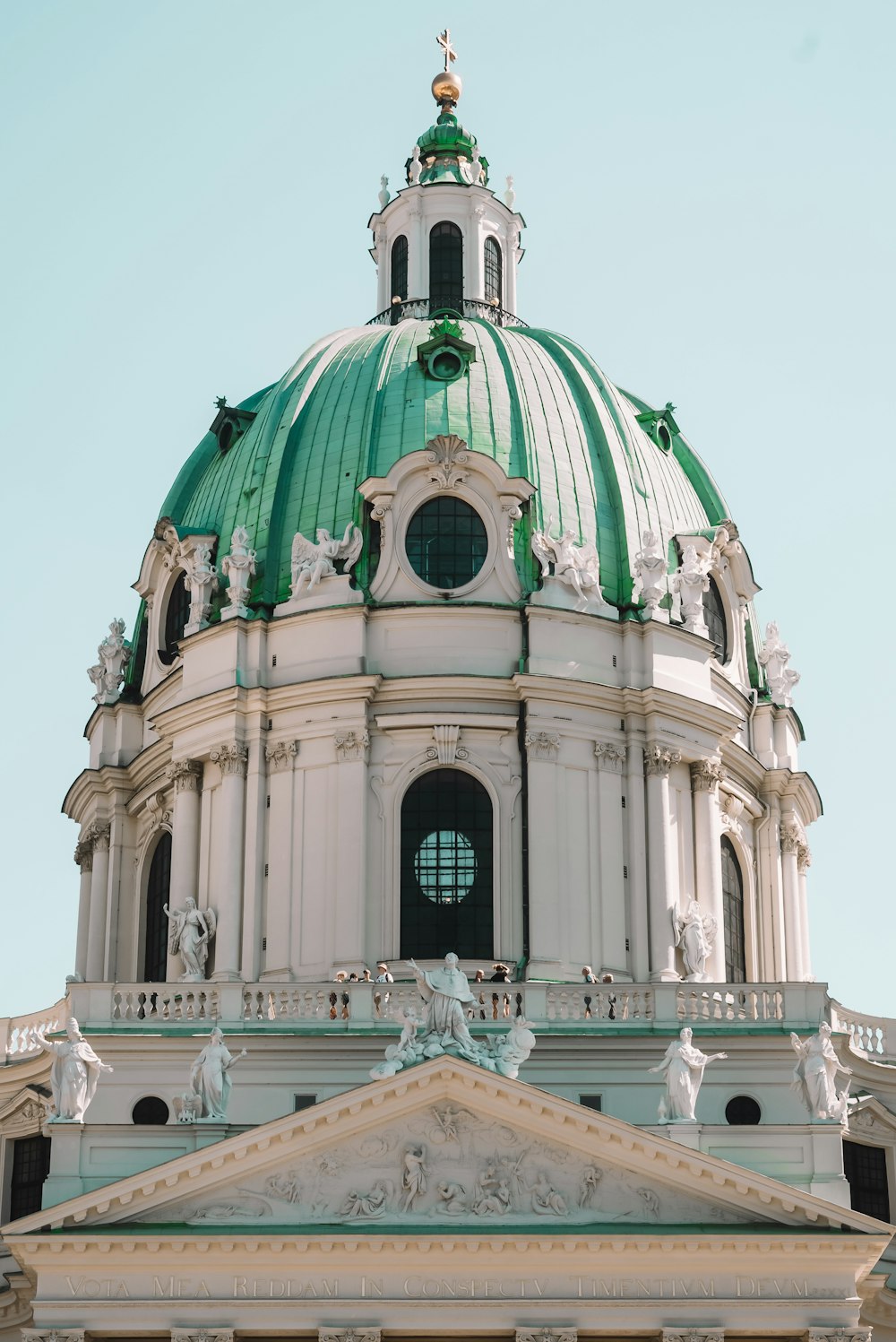 a large white building with a green dome