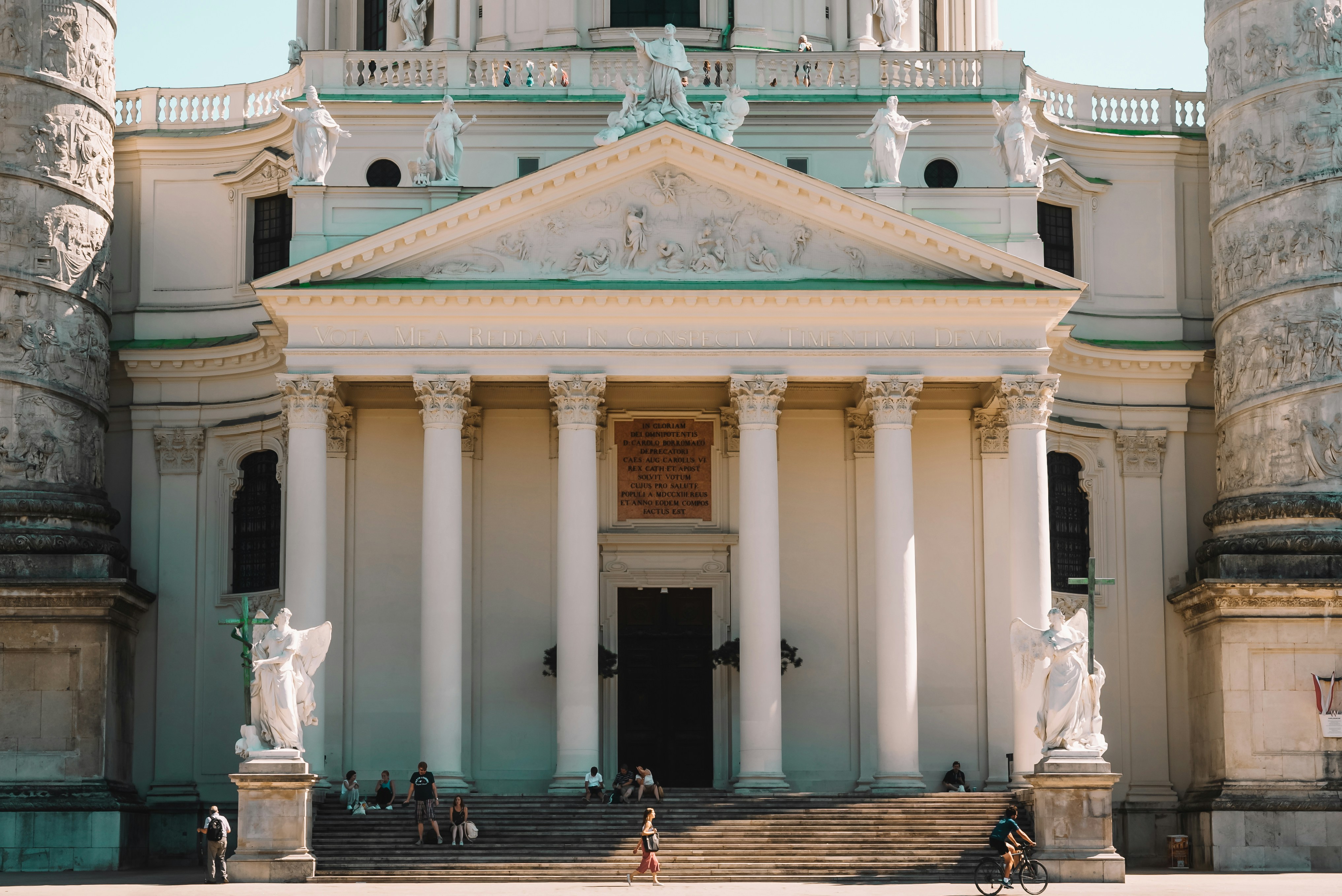 a large white building with columns and a clock tower