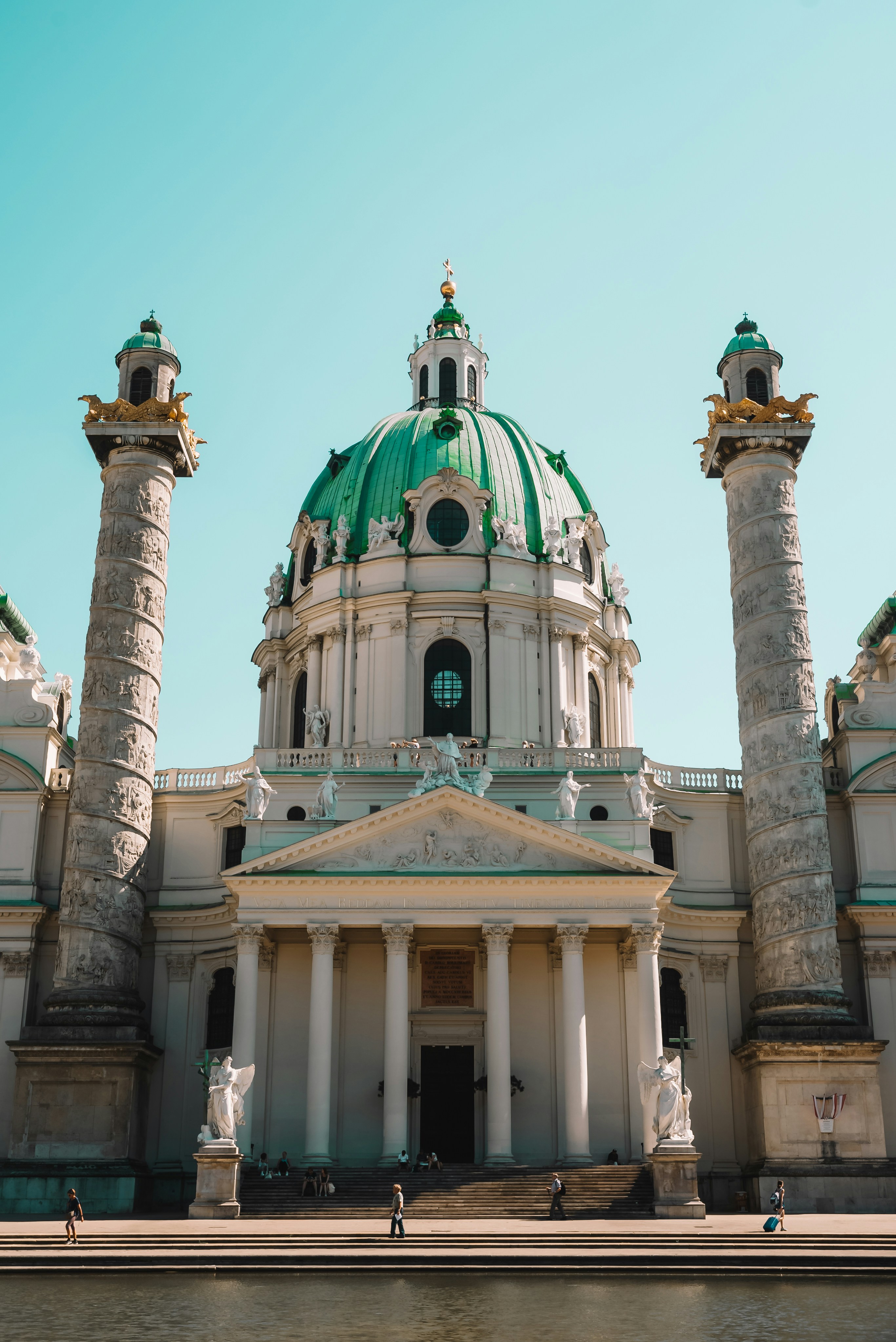a large white building with a green dome