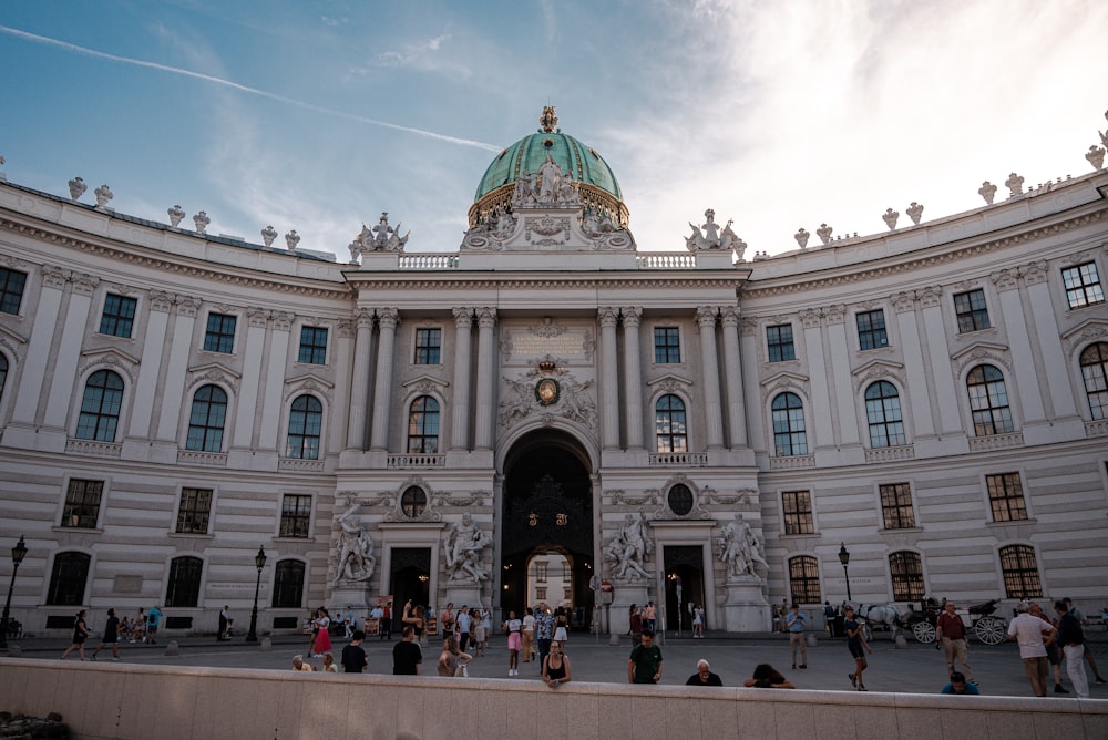 a group of people standing in front of a large building