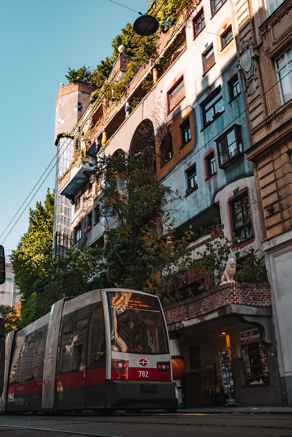 a bus driving down a street next to tall buildings