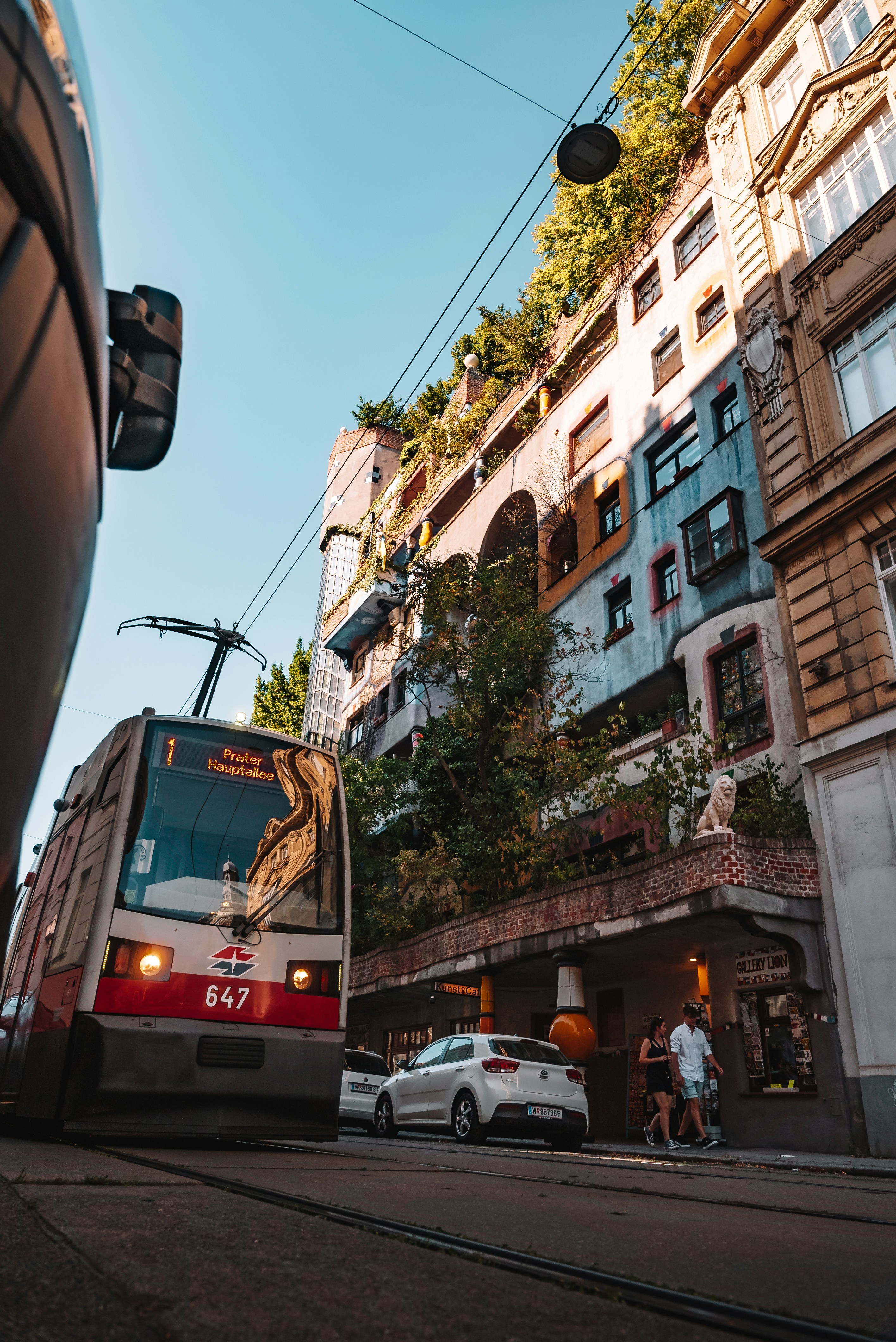 a bus driving down a street next to tall buildings