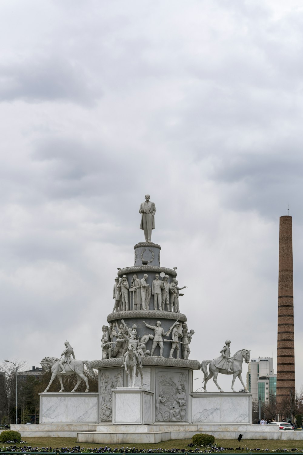 a monument with a statue of a man on top of it