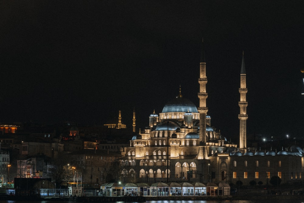 a large building lit up at night with lights on