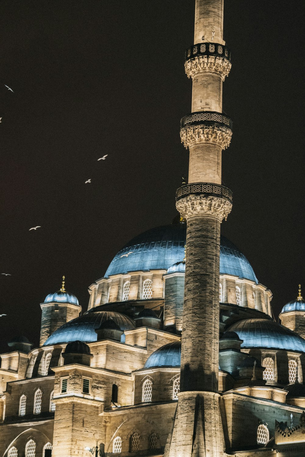 a large building with a blue dome at night