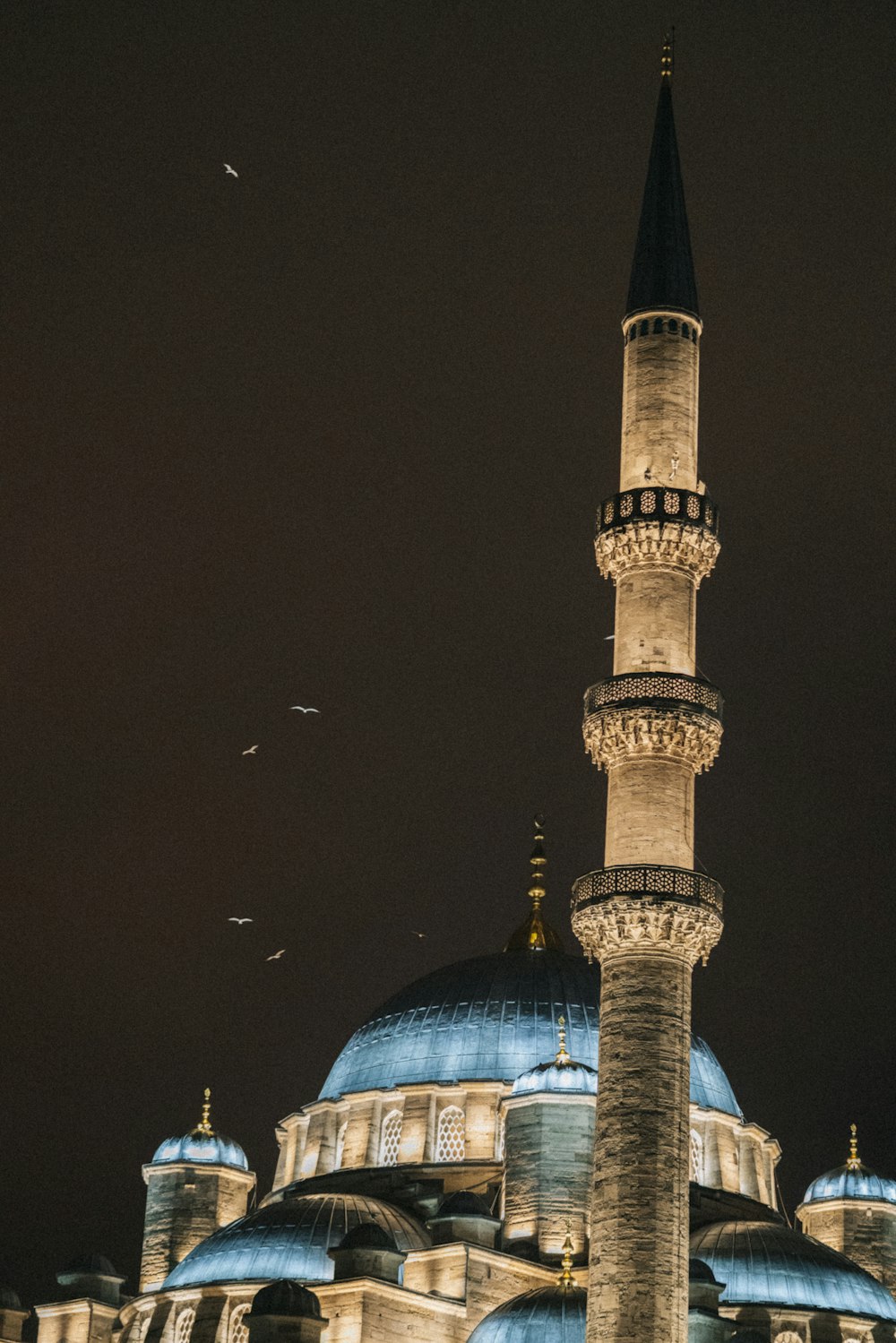 a large building with a blue dome at night