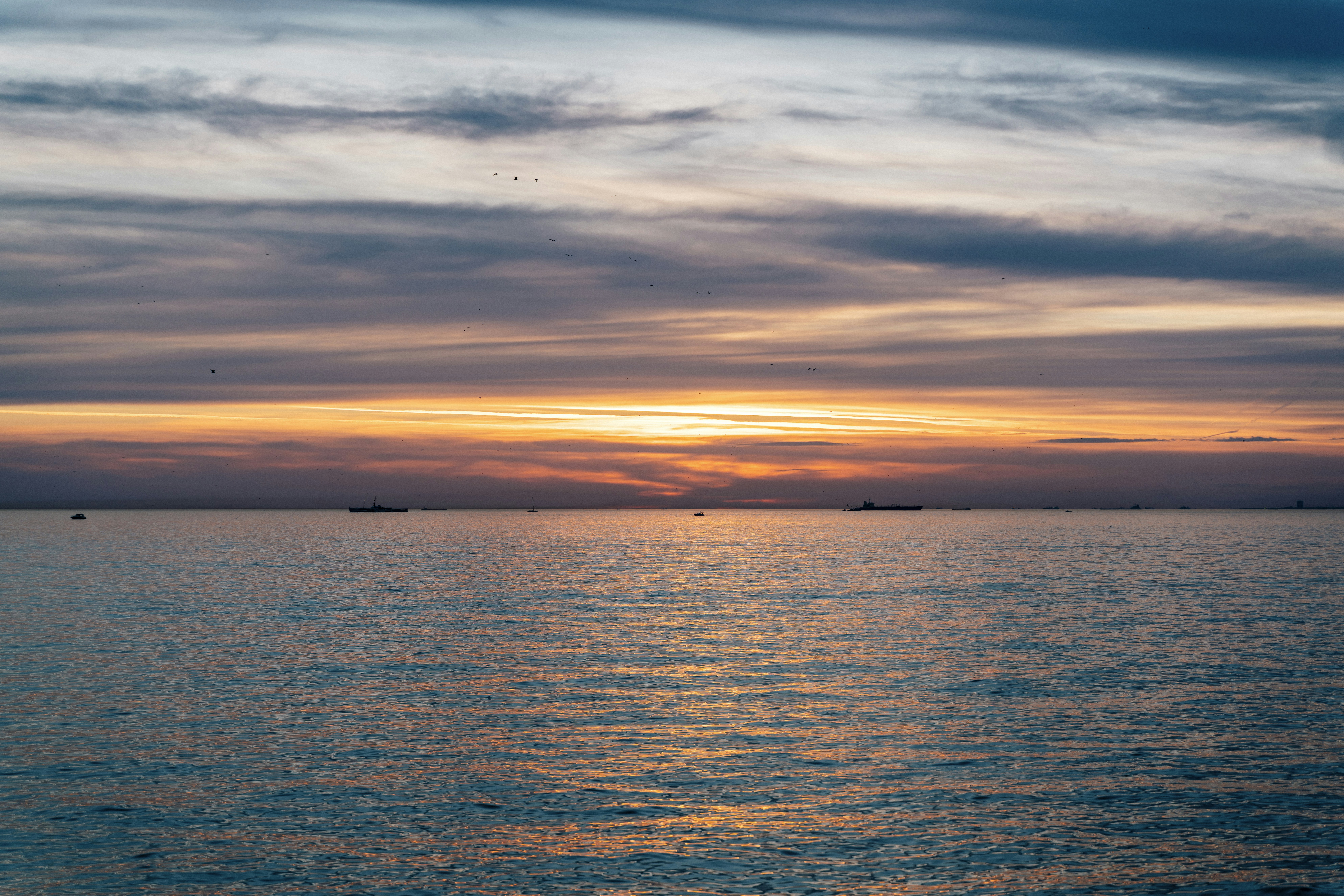 a large body of water under a cloudy sky