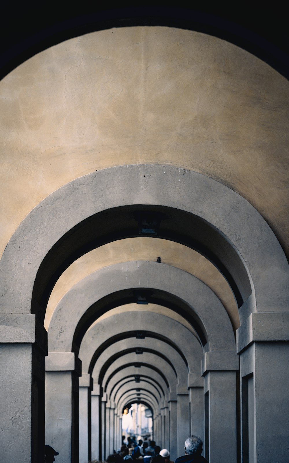 a group of people riding motorcycles down a tunnel