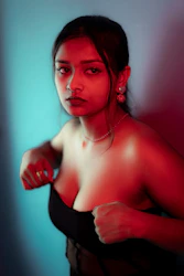 a woman in a black dress posing for a picture