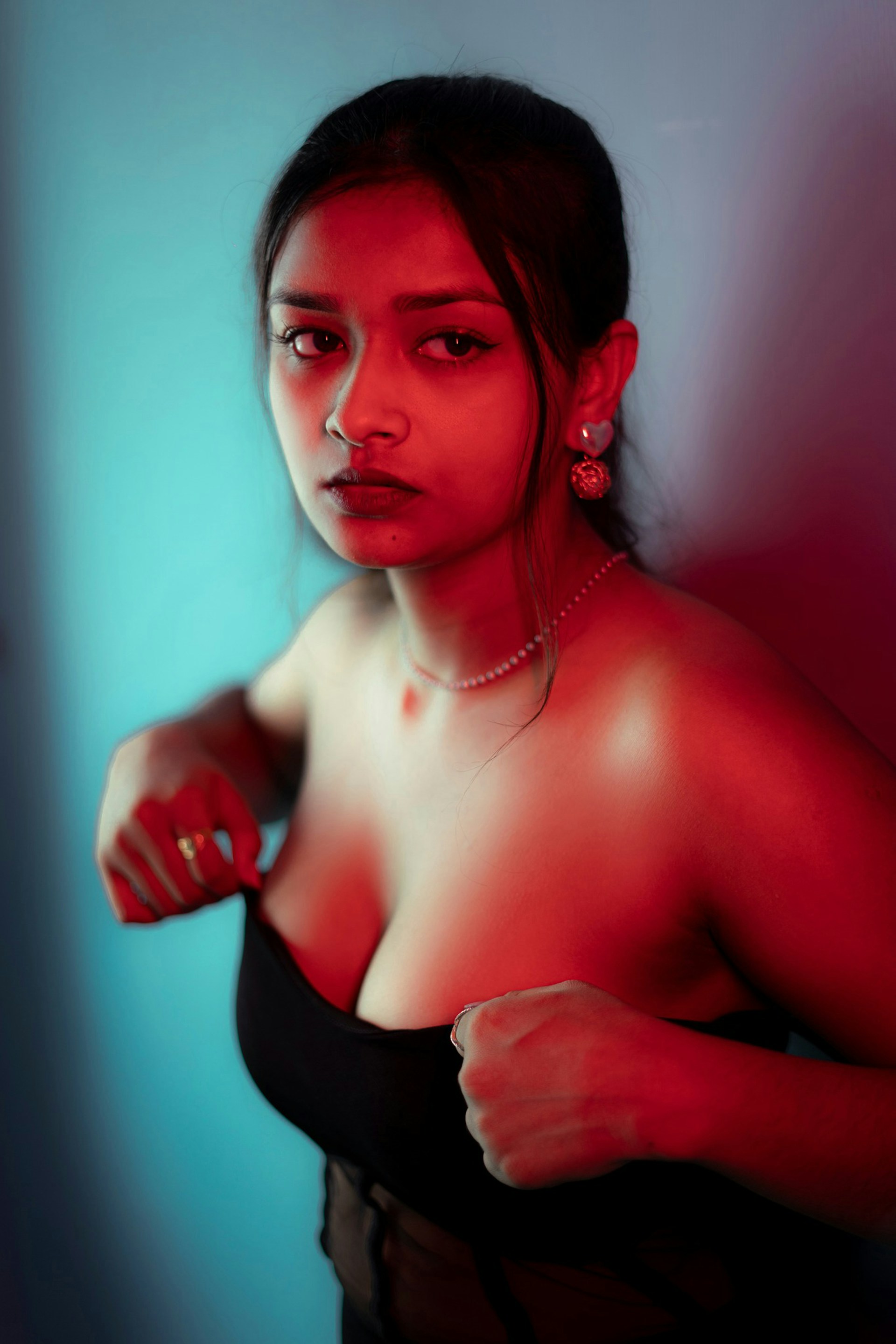 a woman in a black dress posing for a picture