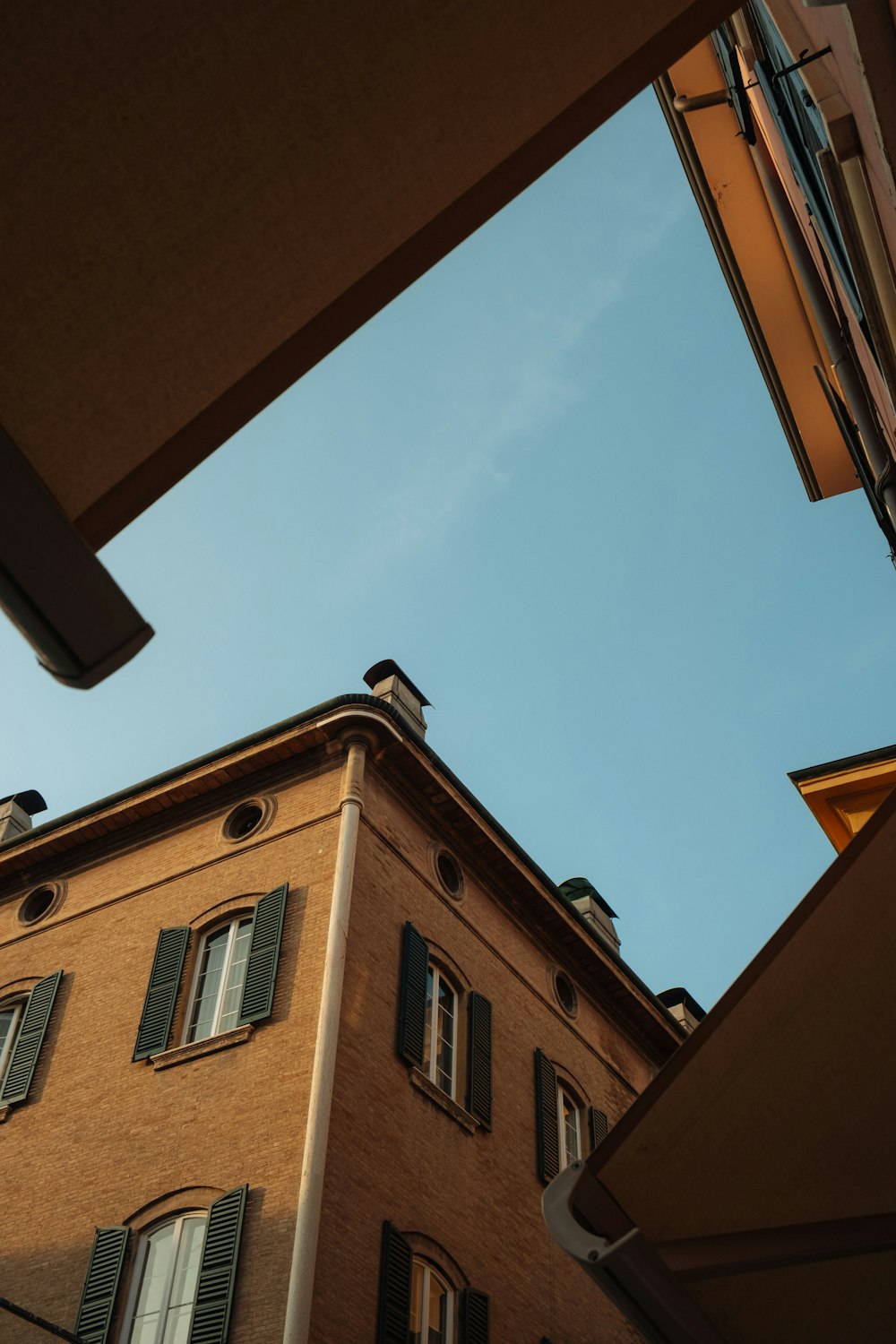 a tall brick building sitting next to a tall building