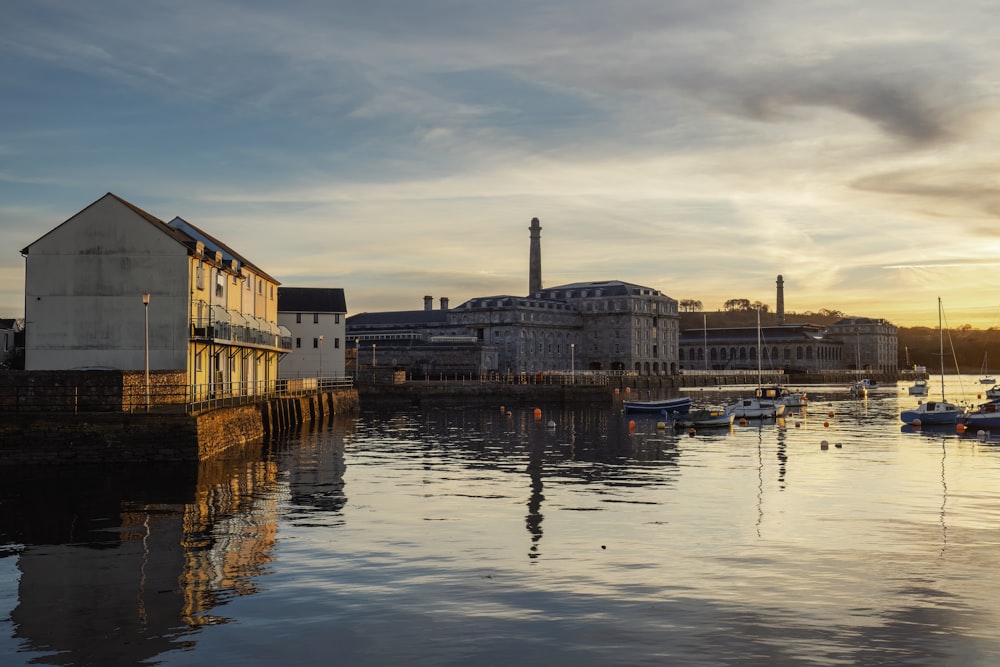 a harbor filled with lots of boats next to a building